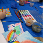 Art Supplies with children painting their canvas