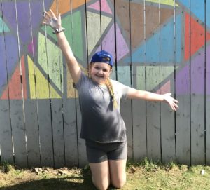 Abbey in front of a colourful geometric chalk drawing.