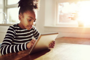 Young black girl browsing on a tablet-pc
