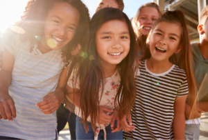 a group of girls standing together smiling