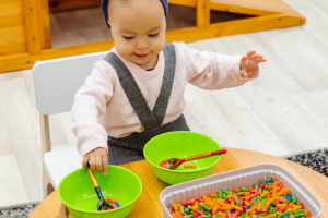 infant playing with a sensory activity