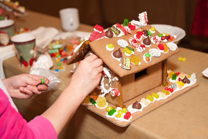 A child building a gingerbread house