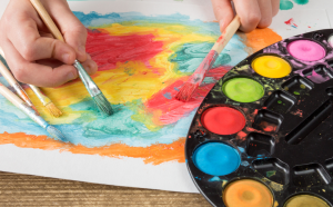 painting with paintbrushes on paper