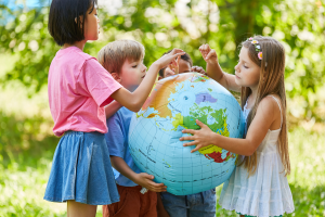 children holding a giant globe 