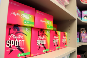 photo of shelf fully stocked with boxes of tampons