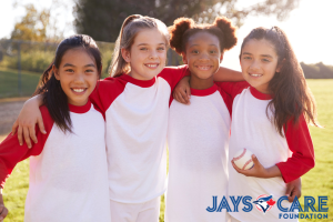 girls in baseball jerseys with the Jays Care Foundation logo