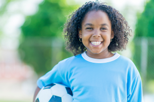 Girl holding a soccer ball