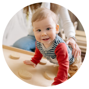 photo of a toddler playing on climbing equipment, looking at the camera