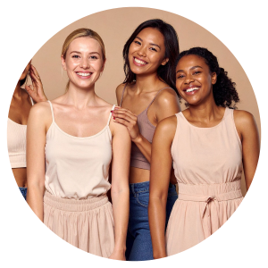 3 women standing together and smiling at the camera
