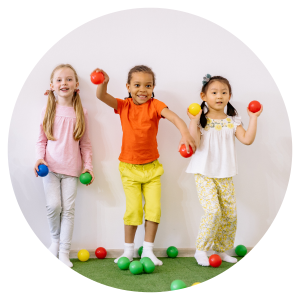 three young girls playing with plastic balls