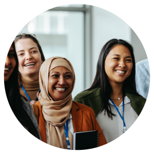 a group of women in smiling in an indoor professional looking setting