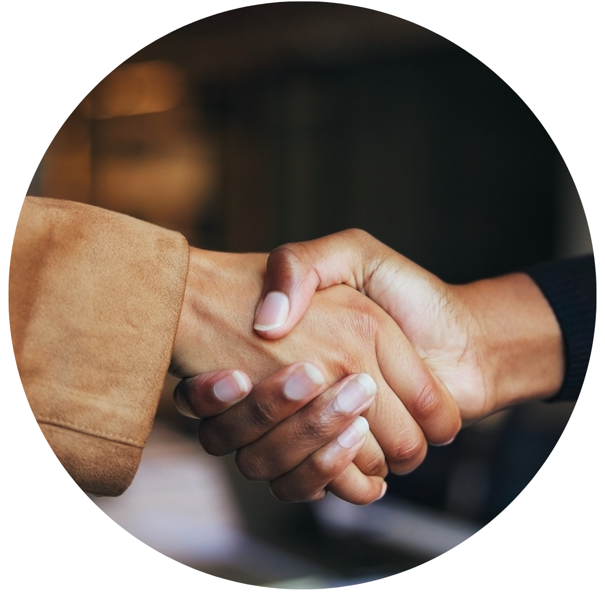 a photo of two hands in business looking attire, shaking on an agreement