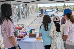 girls selling at a fundraising booth