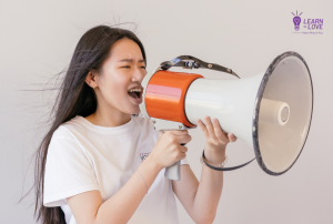 girl yelling into a megaphone