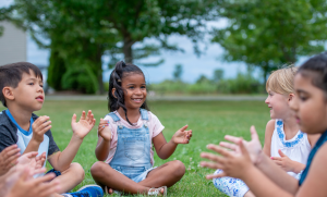 Kids sitting outside at a park