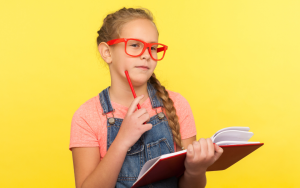 girl thinking holding a pen and notebook