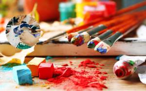 paintbrushes with paint on them resting on a table
