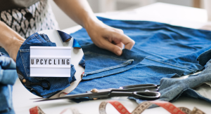 Denim, scissors and thread with a sign that says upcycling