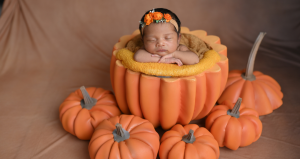 small infant in pumpkin photoshoot