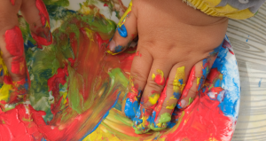 young child's hands in paint